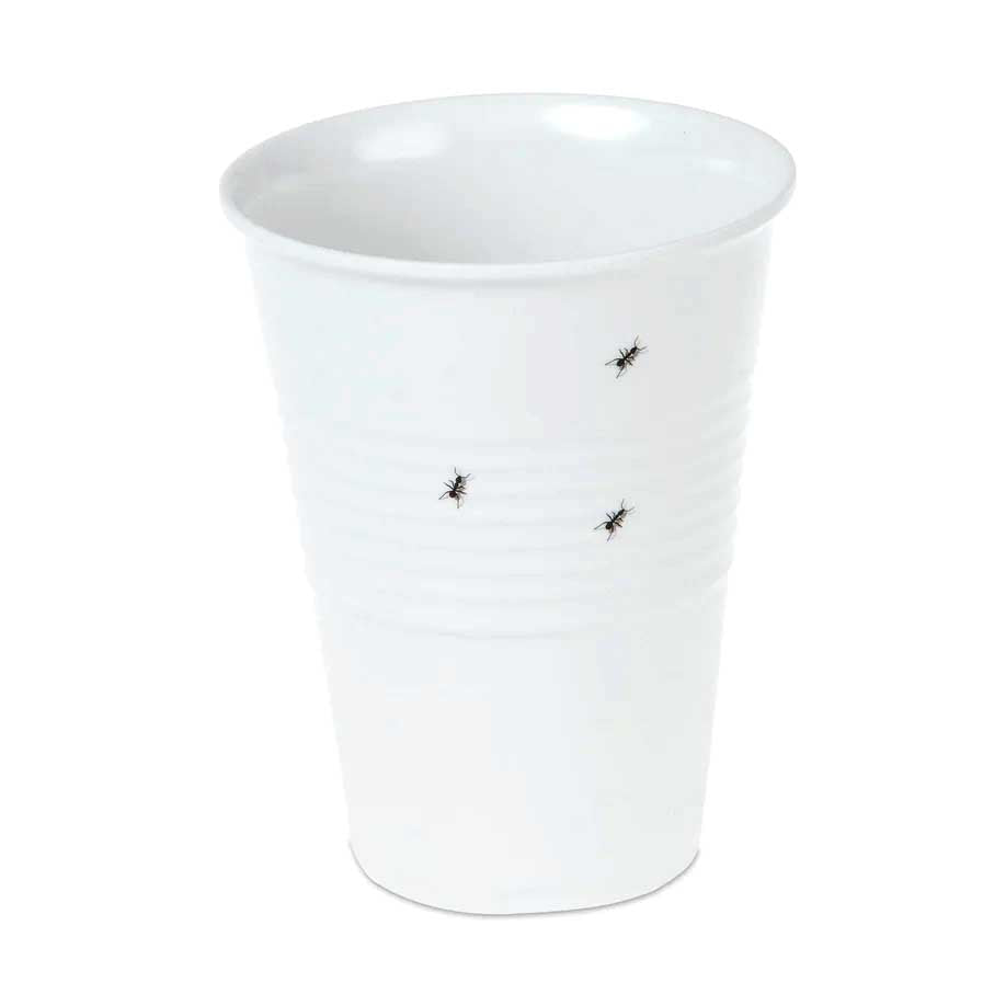 A white melamine white cup showing the print of 3 small ants crawling around