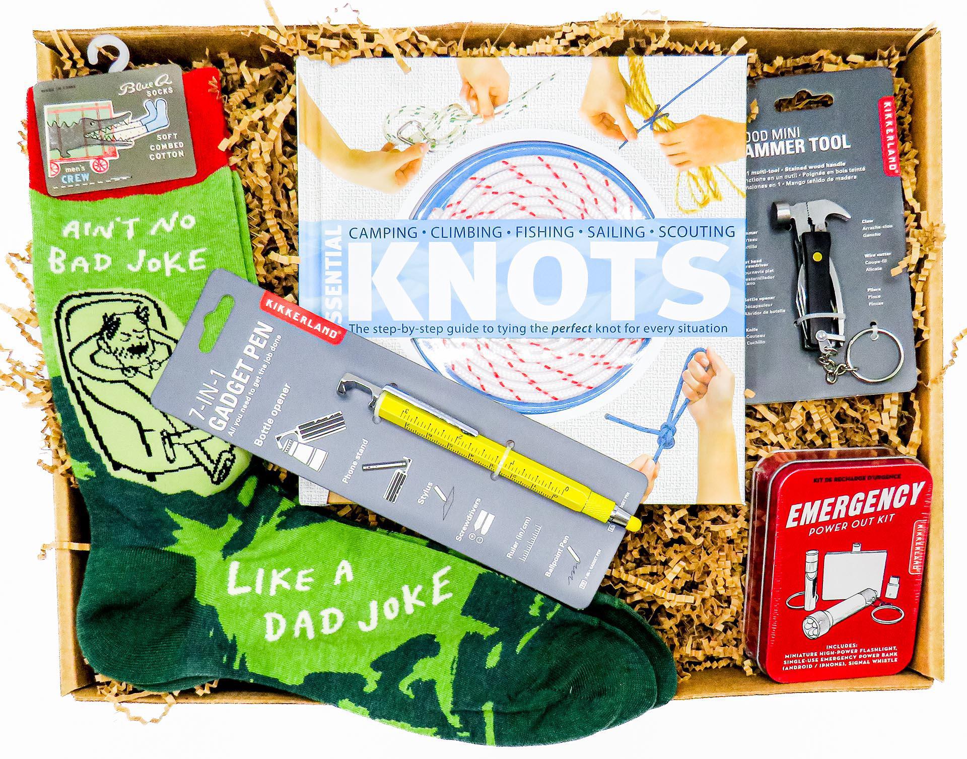 very cool gift box that has a Gadget Pen, Mini Hammer Tool Kit,  "No Joke Like a Dad Joke" Pair of socks ", Essential Knots" Book and Emergency Power Out kit