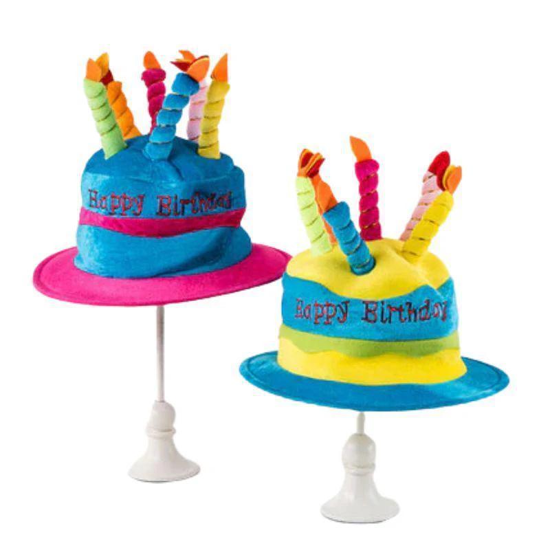 Two colorful birthday cake hats with candles on a white background