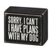 Black wooden block with white text 'Sorry, I can't. I have plans with my dog' on a white background
