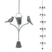 Decorative hanging bird feeder with birds and a bell on a white background