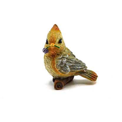 tiny Bird figurine standing on a branch and holding a flower on its peak 