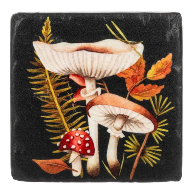 Decorative coaster with mushrooms and leaves on a black background