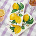 2 lemon themed elegant paper napkins on a table 
