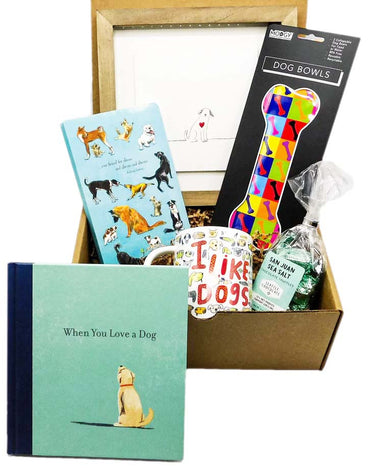 the perfect gift set for dog owners that includes a bag of chocolate truffles, a "I Like Dogs" Mug, a journal, a beautifully framed art piece, The book "When You Love a Dog."  and compact collapsible travel dog bowls.
