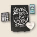 Black towel with 'Love you to the moon & back' text, 'I love that you're my wife' card, and heart-shaped dish on a light background.