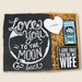 Gift set with 'Love You to the Moon & Back' card, heart-shaped item, and 'I Love That You're My Wife' sign.