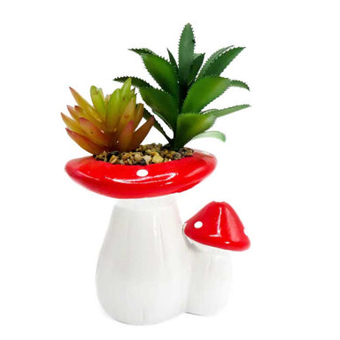 Red and white ceramic planter shaped like 2 mushrooms and  containing 2 different plastic succulents. 