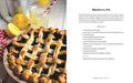 Blueberry pie with lemons and a glass of lemonade on a table, next to a recipe card for Blueberry Pie.