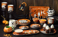 Halloween-themed tableware set with mugs, plates, and bowls featuring ghost and pumpkin designs.