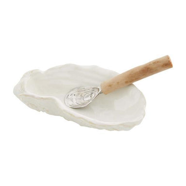 White ceramic oyster dish with a wooden-handled shell spoon on a white background