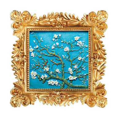 Paint your own almond blossom art. Decorative artwork of floral branches on a blue background, framed in an ornate gold frame.