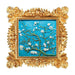 Paint your own almond blossom art. Decorative artwork of floral branches on a blue background, framed in an ornate gold frame.