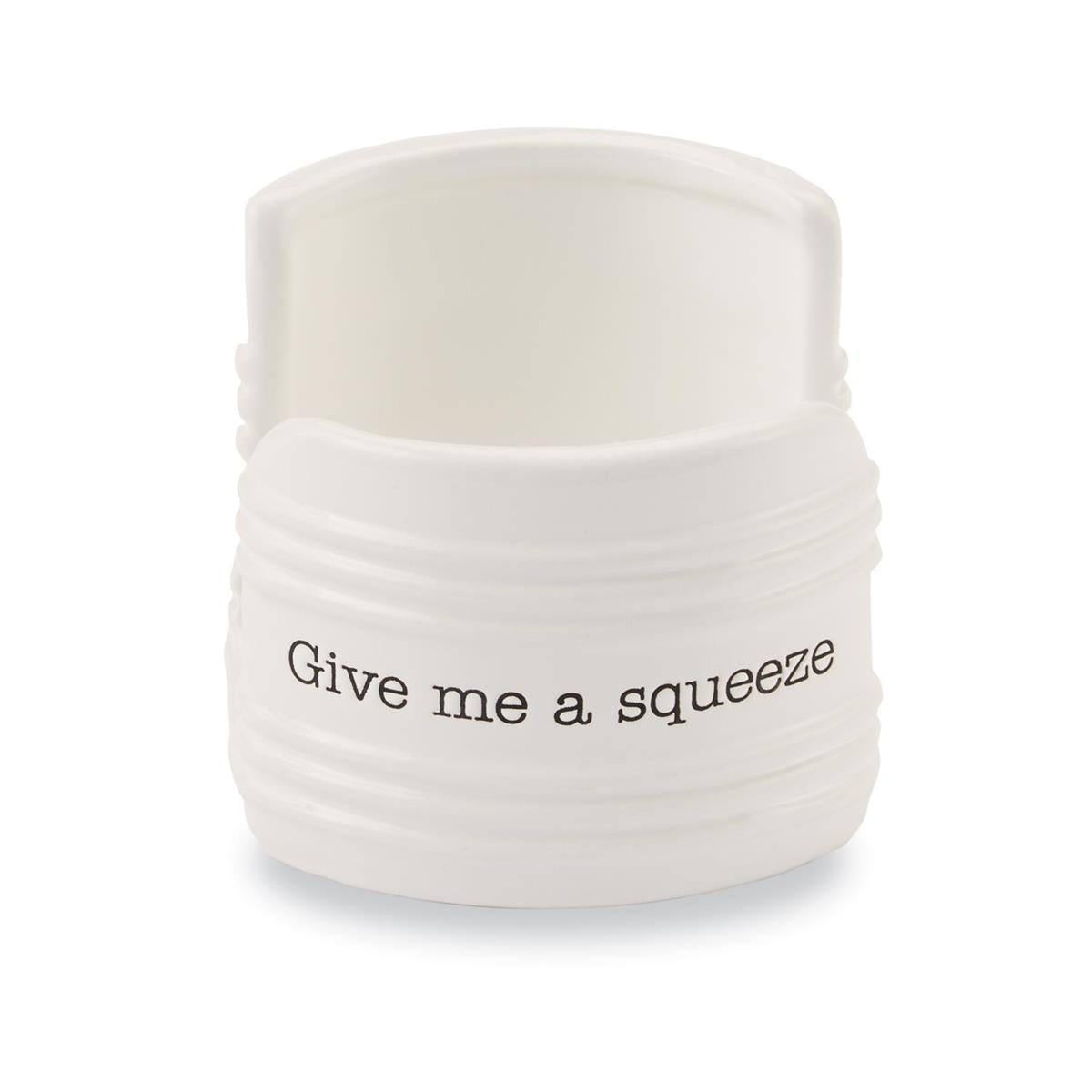 chic and functional white  ceramic sponge holder with the legend "Give me a squeeze"