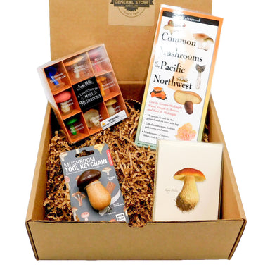 Box Packed with a guide of common mushrooms from the Pacific Northwest, boxed blank notes featuring charming mushroom drawings, a Mushroom Tool Keychain, and a box of mini mushrooms