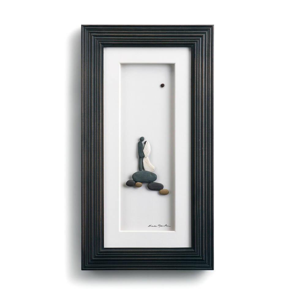 "From This Moment" framed art by Sharon Nowlan. This minimalist piece, crafted from sea glass and stone, depicts a loving couple on a hilltop